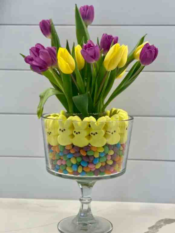 Trifle dish with candy and flowers.
