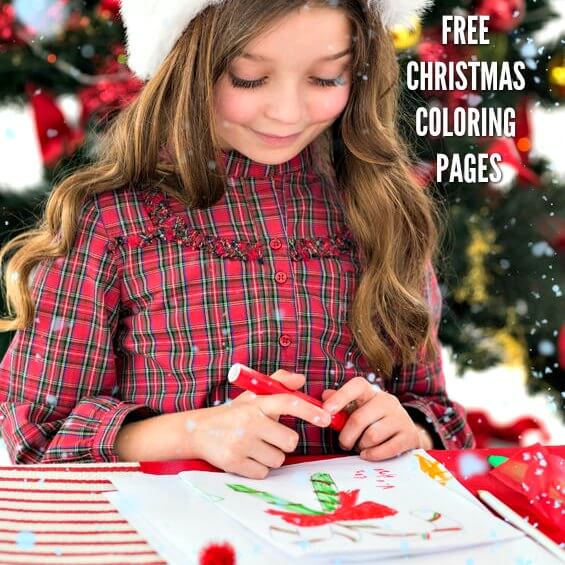 Child coloring by the Christmas tree. 