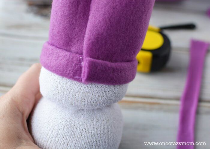 Securing the fabric with hot glue. 