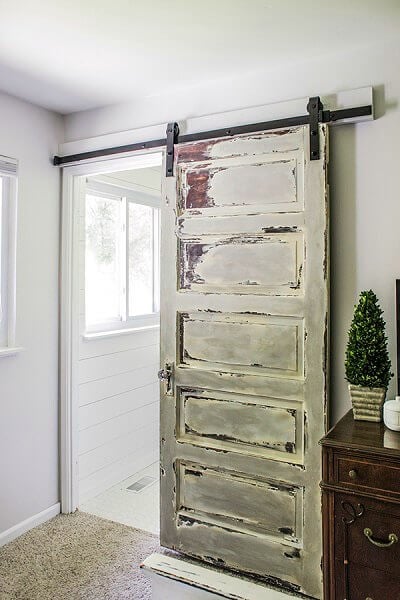 Rustic barn door beside table. 