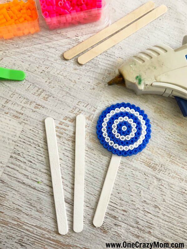 Perler beads are so fun and this Lollipop Perler Beads Craft is the perfect activity for the kids. This craft idea is simple and frugal but a blast to make!