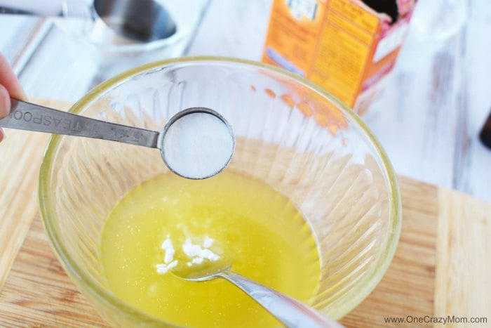 Measuring spoon with ingredients being combined. 