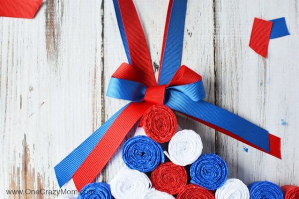 This DIY 4th of July wreath is made with crepe paper and takes very little time to make! Try this Fourth of July wreath with dollar store supplies! 