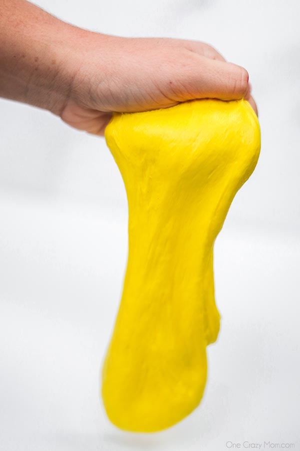 Butter slime stretched with a hand. 