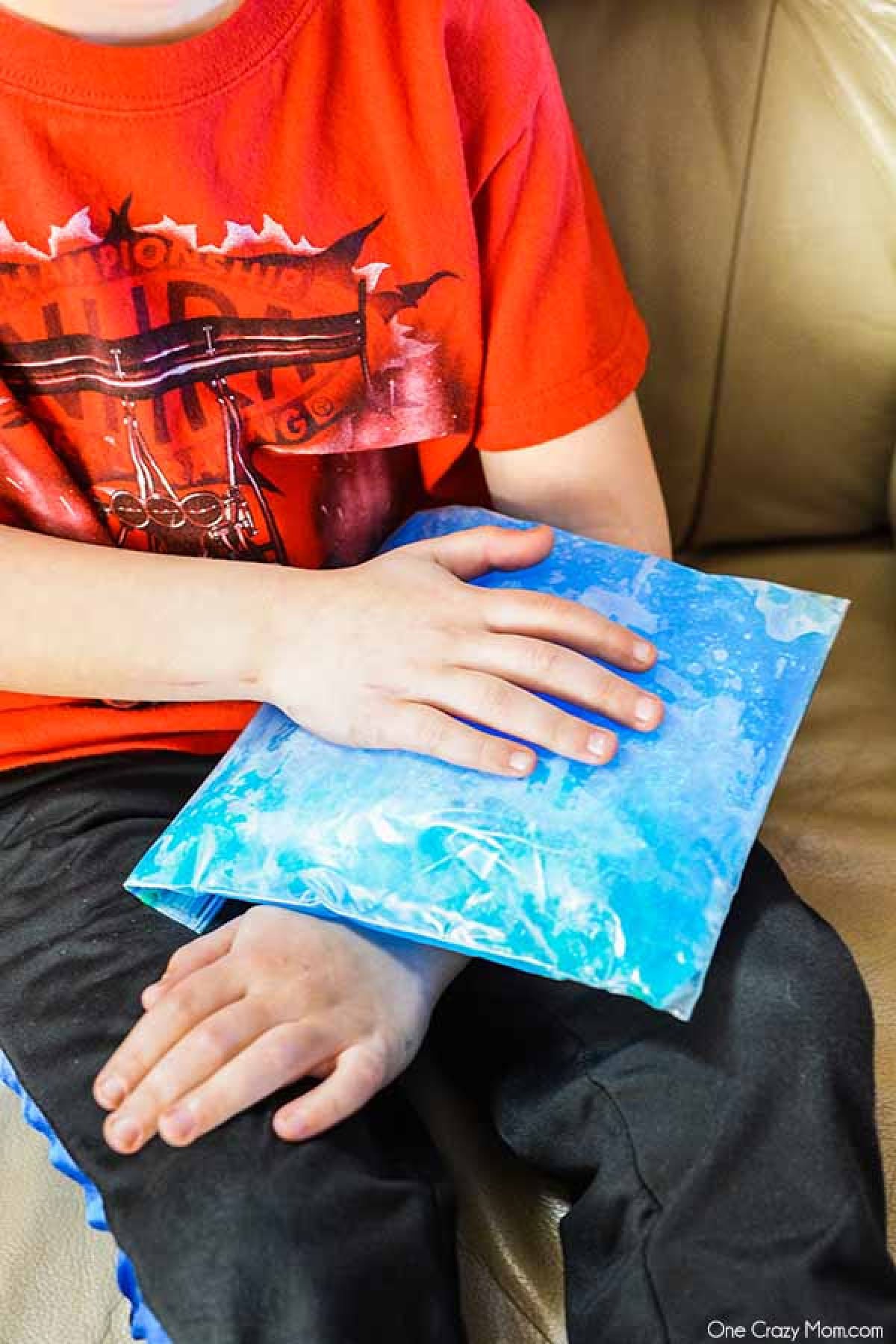 Child with ice pack on arm. 