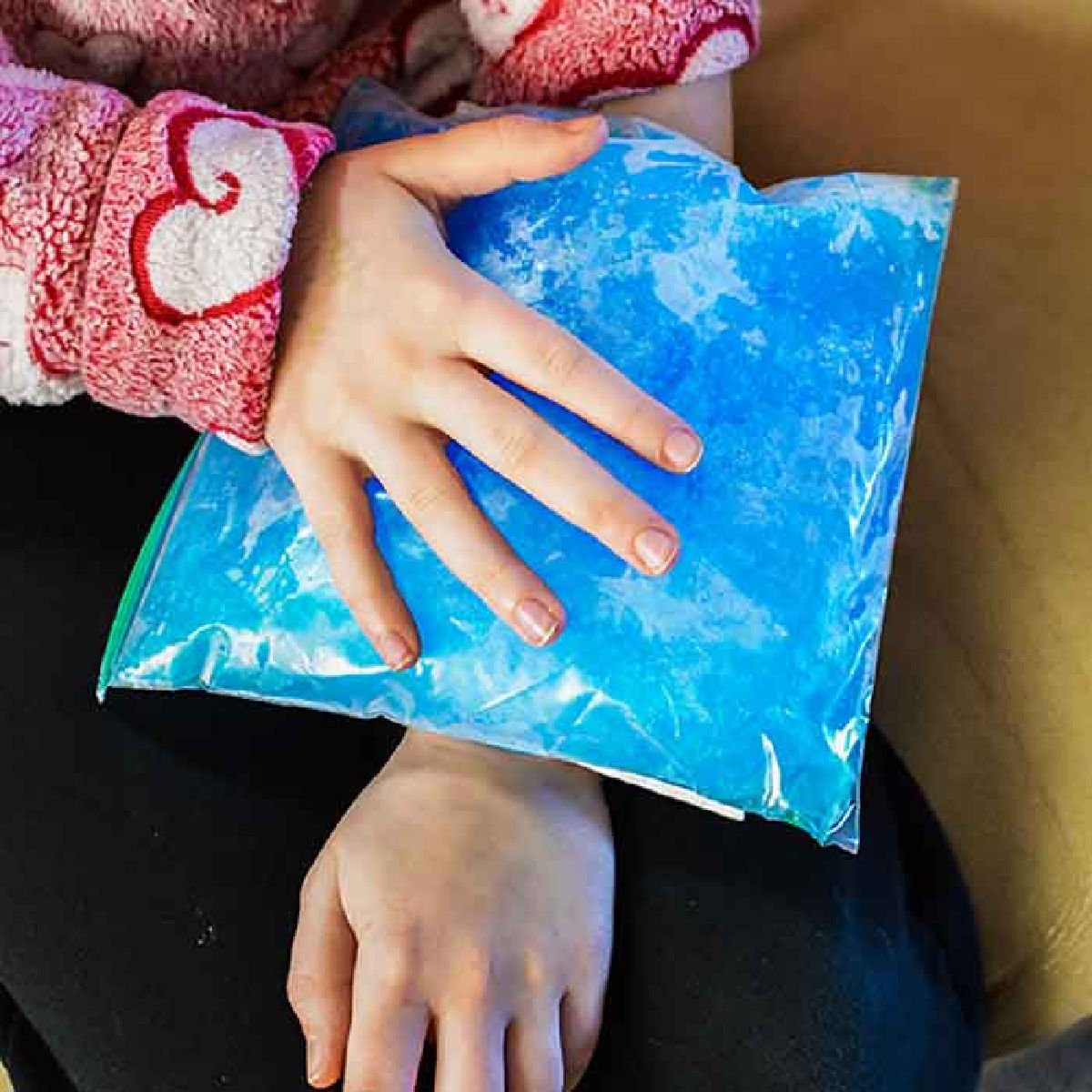 Child with ice pack on arm. 