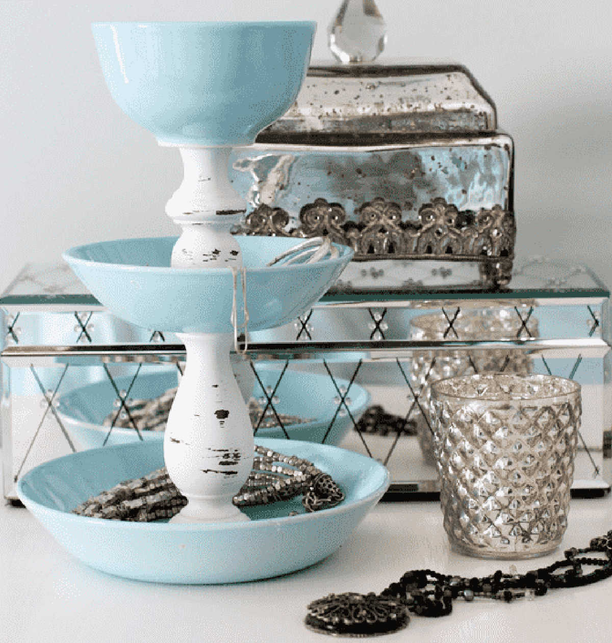 DIY jewelry storage with candlesticks.