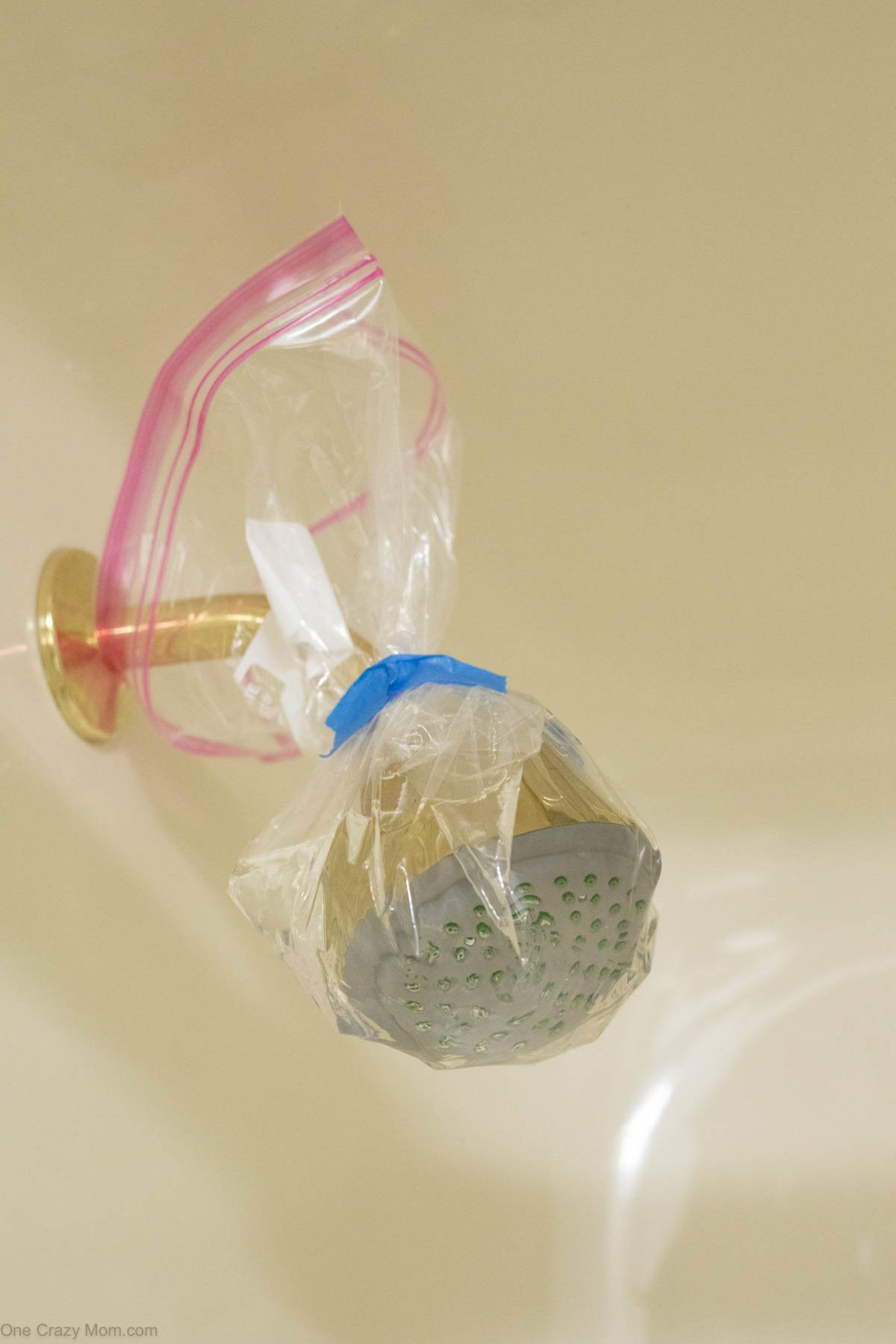 Shower head wrapped in a bag soaking. 