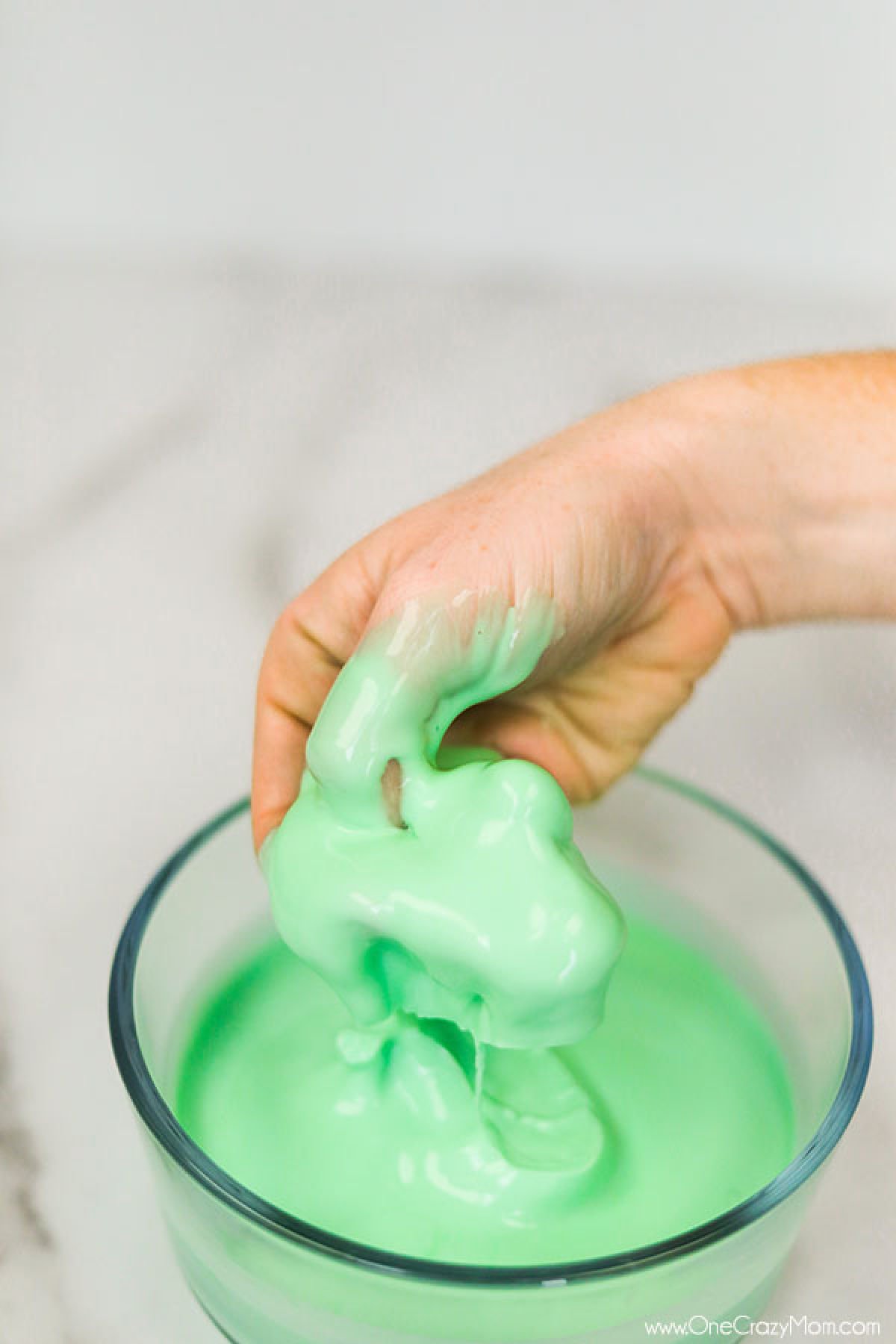 Oobleck in bowl with hand in it. 