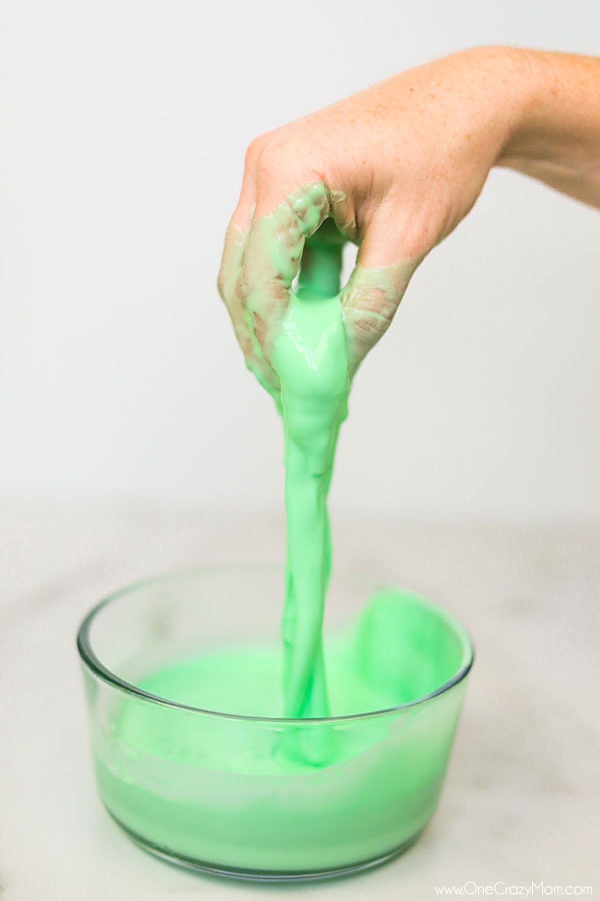 Oobleck in bowl with hand in it. 