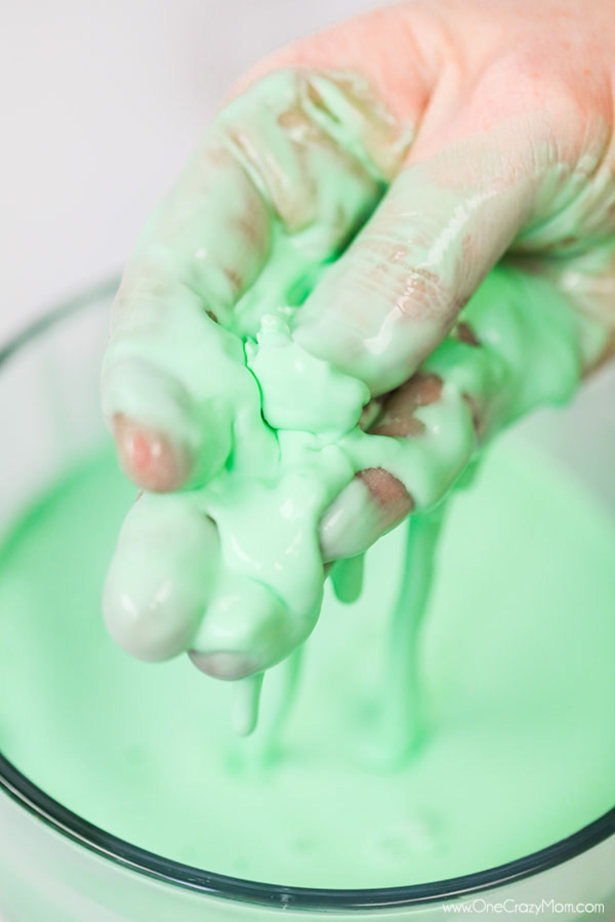 Oobleck in bowl with a hand dipped in it. 