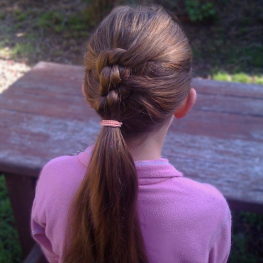 Ponytail in triple know on a child.